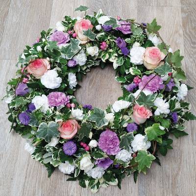 pink, purple and white flower and foliage funeral tribute wreath 