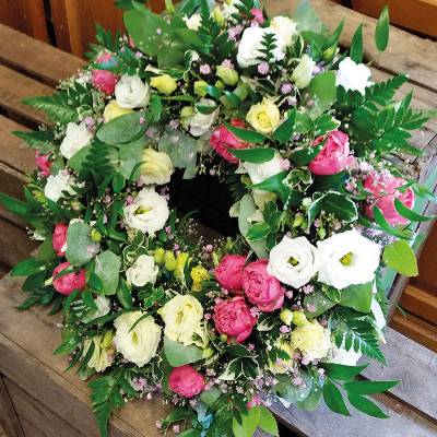 Pink and white flower and foliage funeral tribute wreath 