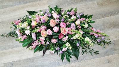 Pink and pastel flower and foliage double ended funeral coffin spray 