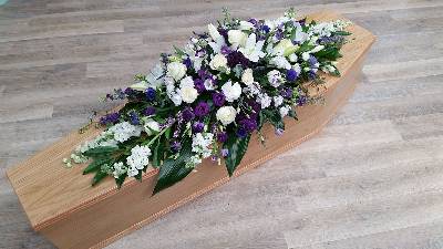 Purple and white lily and rose scented flower and foliage double ended funeral coffin spray 
