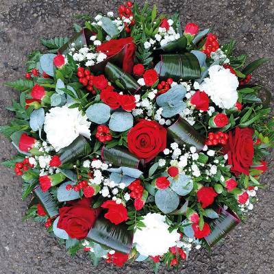 Red and white funeral tribute flower and foliage posy with roses and gypsophila 