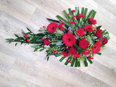 Red gerbera and rose single ended flower and foliage funeral coffin spray