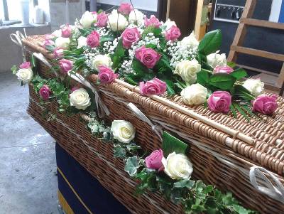 Garland of flower and foliage coffin handles including ivy and roses for wicker funeral caskets