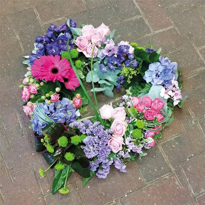 textured pink and purple flower and foliage open heart funeral tribute 