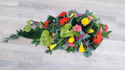 Contemporary flower and foliage single ended funeral coffin spray 