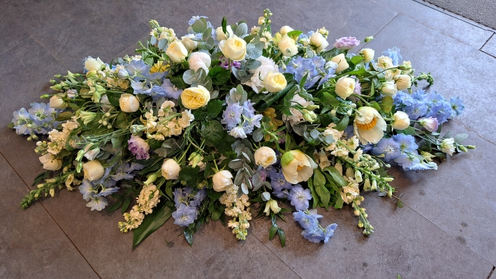 Blue and White coffin spray with delphiniums, white roses and scented stocks