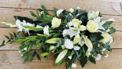 White flower and foliage single ended funeral coffin spray with lilies and roses