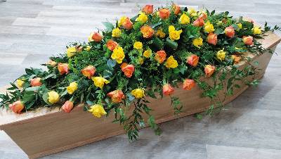 yellow and orange rose flower and foliage double ended funeral coffin spray with ivy and soft ruscus trails