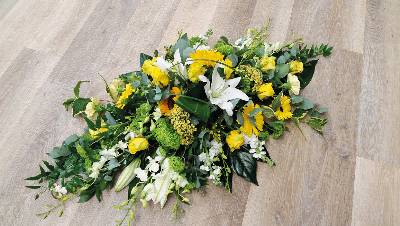 Yellow and white flower and foliage double ended funeral coffin spray inlcuiding lilies and euchalyptus 