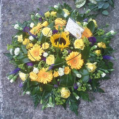 Yellow and purple funeral tribute flower and foliage posy