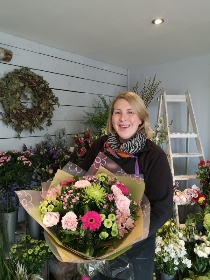 bright handtied flower bouquet gift wrapped aqua pack of water, held by our local florist