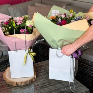 handtied flower bouquet gift wrapped in an a bubble of water or gift bag for monthly subcription service