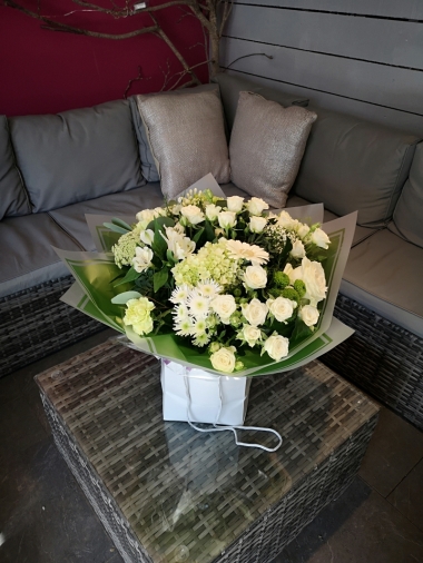 handtied flower bouquet gift wrapped in an a bubble of water or gift bag for monthly subcription service
