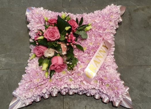 Pink chrysanthemum based cushion funeral flower tribute with ribbon 