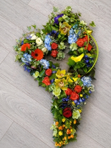 Mixed textured flower and foliage open heart funeral tribute 