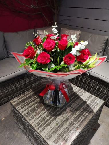 one dozen large red rose flower and mixed foliage handtied bouquet gift wrapped