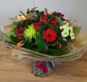 Festive red and green christmas flower bouquet in bubble of water