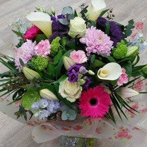 handtied flower bouquet gift wrapped in an a bubble of water or gift bag for monthly subcription service