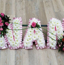 White based chrysanthemum mum letter funeral tribute with flower spray and pink ribbon edge