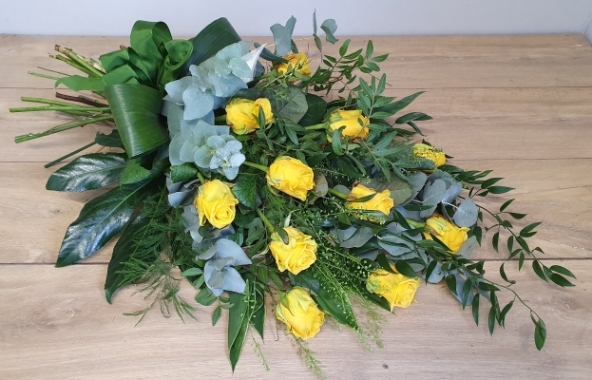 A beautiful sheaf of 12 premium bright yellow roses with an abundance of gorgeous foliage.