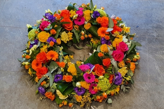 A bright carnival mix of flowers including oranges, yellows and lime greens.