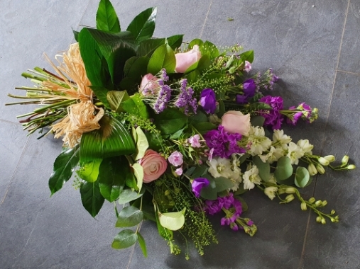 Hand-tied funeral sheaf with cottage garden style flowers and foliage