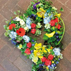 Mixed textured flower and foliage open heart funeral tribute 