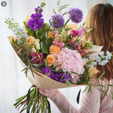 large wild style flower handtied bouquet in a vase