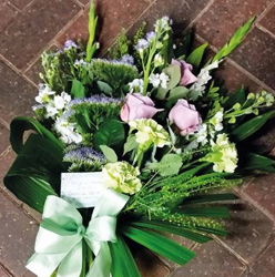 Pastel pink and lilac flower and foliage funeral tribute sheaf 