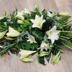 White flower and foliage single ended funeral coffin spray with lilies 