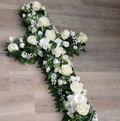 white flower and foliage cross funeral tribute 