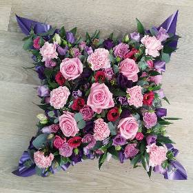 Pink and purple loose cushion funeral flower tribute with ribbon 