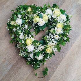 Loose white and ivory flower and foliage open heart funeral tribute 