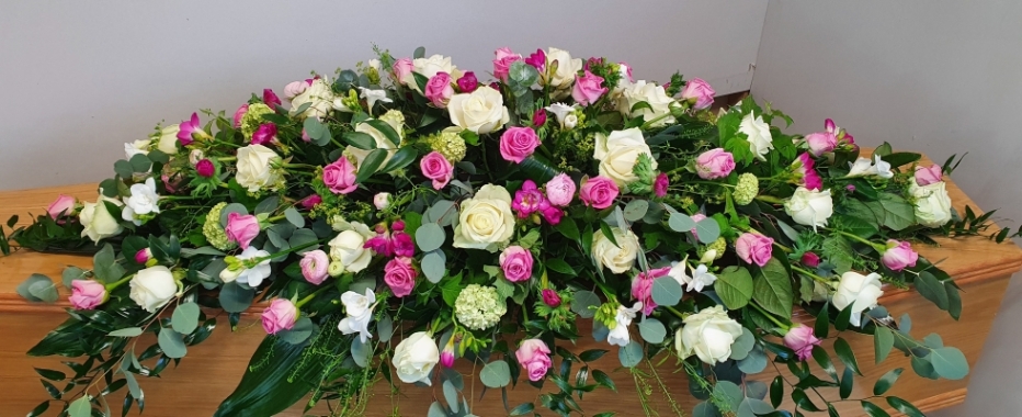 Loving Memories Double Ended Coffin Spray - a mix of white roses, pink roses, pink ranunculus, white freesias, and lush greenery