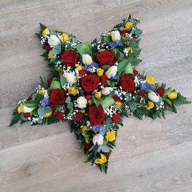 Bright rose flower and foliage star funeral tribute 