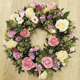 Mixed rose flower and foliage funeral tribute wreath 