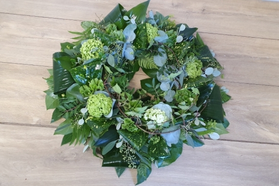 A beautiful foliage funeral wreath with mixed natural foliage.