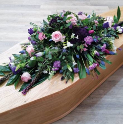 pastel pink, lilac and purple flower and foliage double ended funeral coffin spray with eucalyptus 