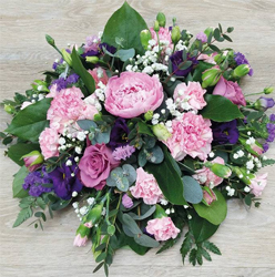 Pink and purple funeral tribute flower and foliage posy