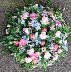 Baby blue and pastel pink flower and foliage posy funeral tribute