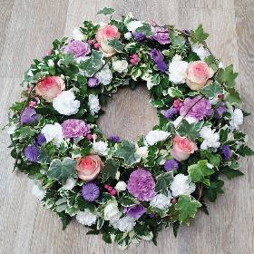 pink, purple and white flower and foliage funeral tribute wreath 