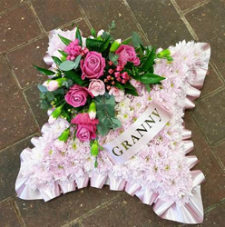 Pink chrysanthemum based cushion funeral flower tribute with ribbon 