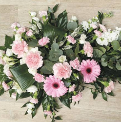 Pastels, baby pink and white flower and foliage single ended funeral coffin spray