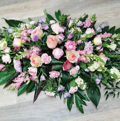 Pink and pastel flower and foliage double ended funeral coffin spray 