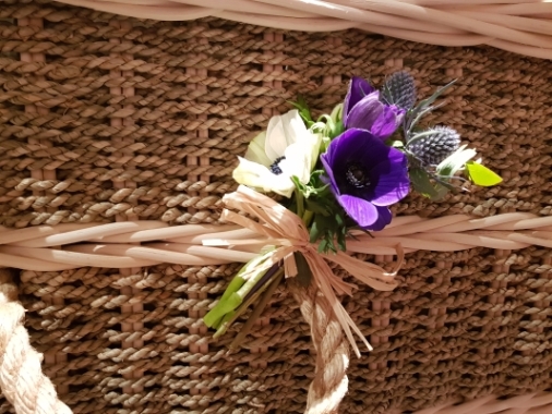 A rustic spray placed on each coffin handle of anemone and thistle 