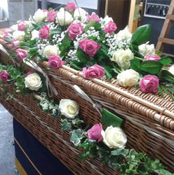 Garland of flower and foliage coffin handles including ivy and roses for wicker funeral caskets