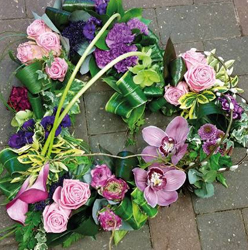 Pastel pink and purple flower and foliage open heart funeral tribute 