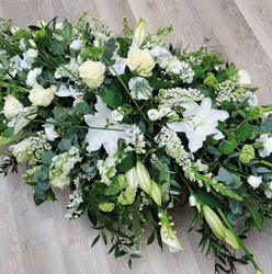 White, ivory and green flower and foliage double ended funeral coffin spray with lilies