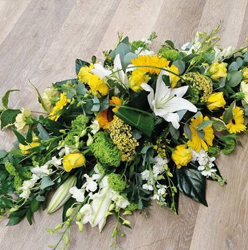 Yellow and white flower and foliage double ended funeral coffin spray inlcuiding lilies and euchalyptus 