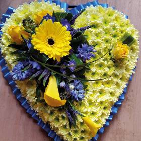 blue and yellow chrysanthemum flower heart funeral tribute with ribbon